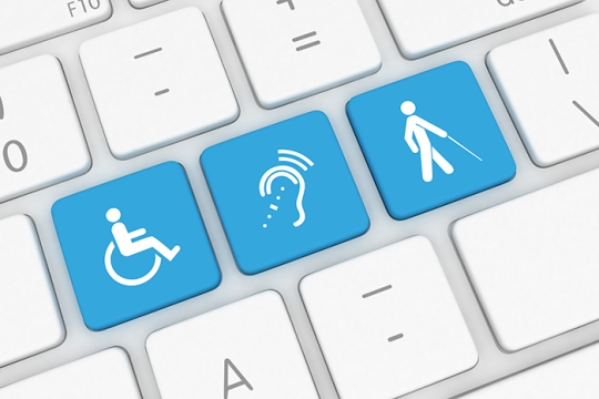 Photo of blue and white keys on a computer keyboard that represent different disabilities